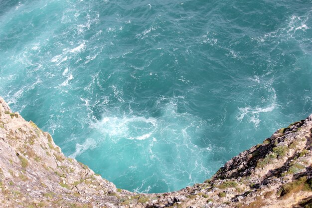 Waves breaking on the cliff