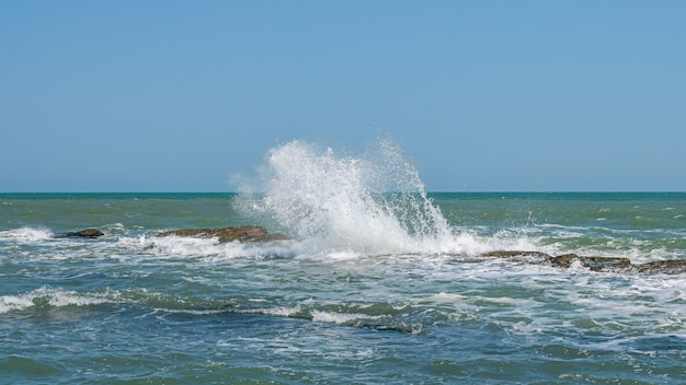 Waves breaking on coastal reefs, big splashes