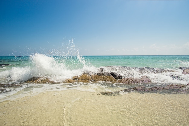 Waves breaking on the rock on the Caribbean beach