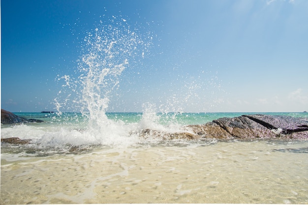 Waves breaking on the rock on the Caribbean beach