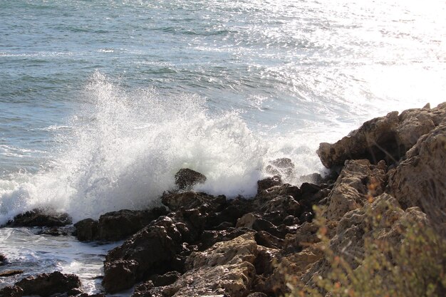 Premium Photo | Waves breaking on rocks