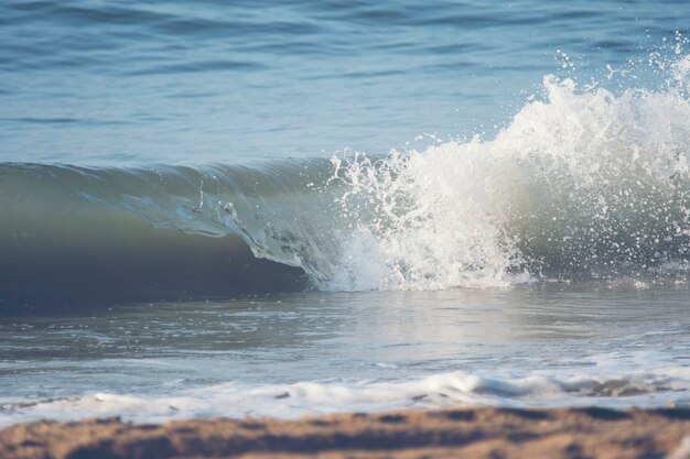 Waves breaking sand beach