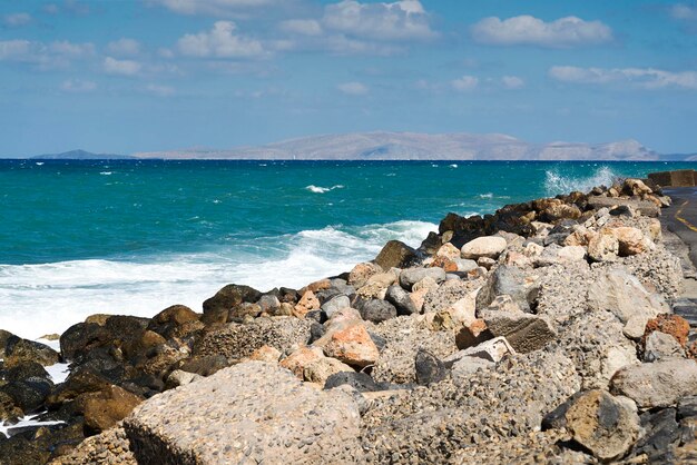 Waves crash on the rocky beach forming splashes Waves and splashes on the beach