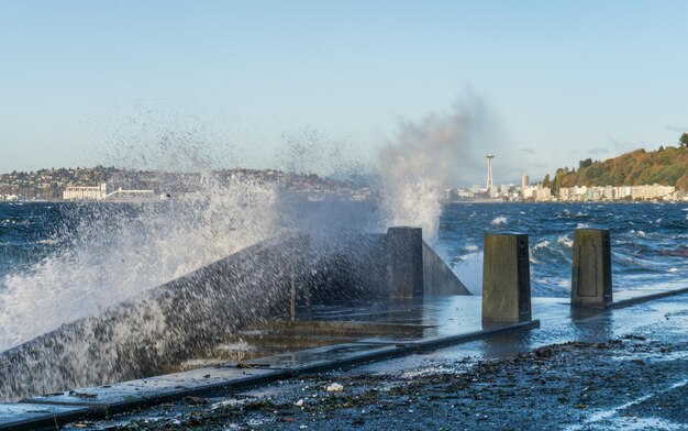 Photo waves crash on the waterfront at alki beach in west seattle washington