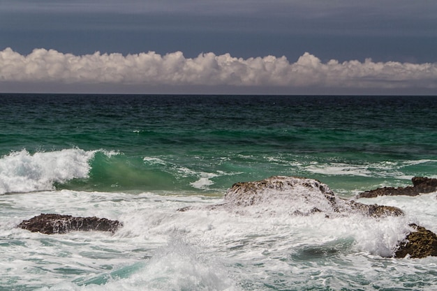 The waves fighting about deserted rocky coast of Atlantic ocean Portugal