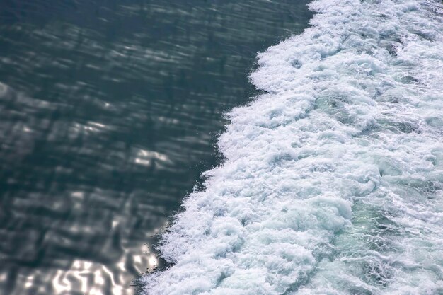 The waves from the ship on the background of the tranquil\
ocean