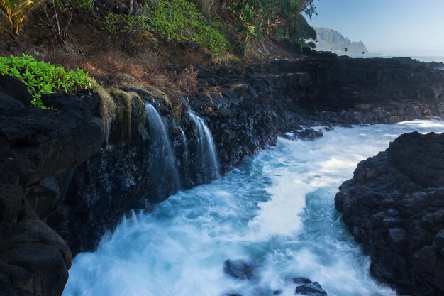 Waves hit rocks at Queens Bath Kauai