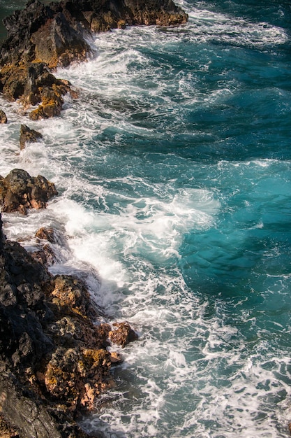 Waves hitting the rocks rocky cliffs on sea seascape