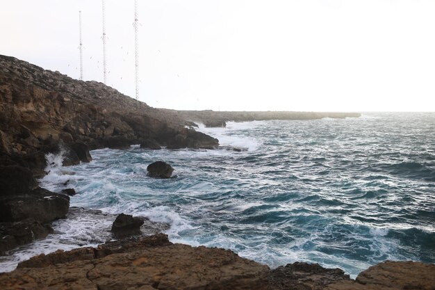 Waves hitting the rocky cliffs in a beach located in CyprusThis weather might be dangerous for water sports but simultaneously the waves and their splashes are pretty and wild