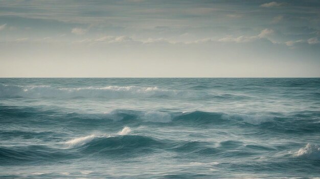 Waves in a ocean with blue sky with clouds background