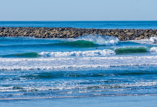 Waves roll in along the jetty in westport washington