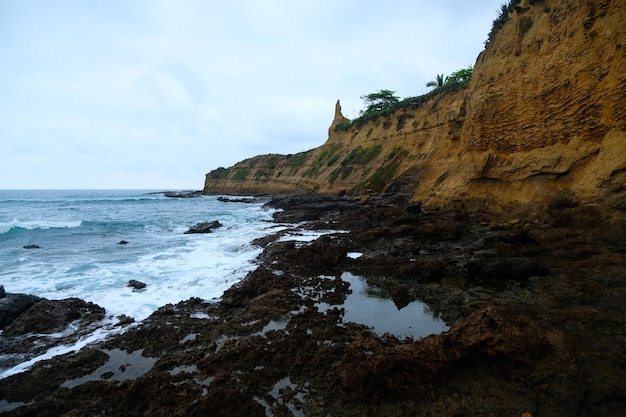 Waves on the seaside are splashing on the rocks in a stormy day