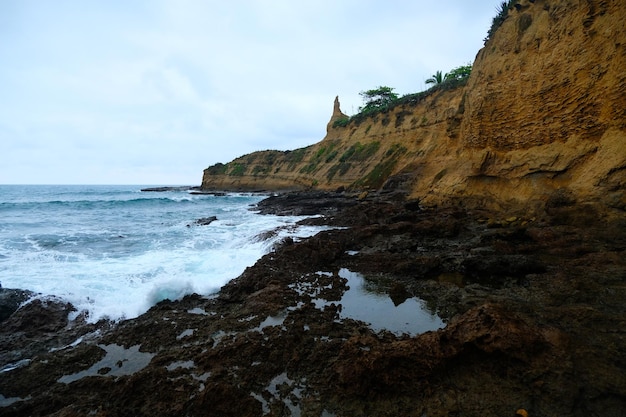 Waves on the seaside are splashing on the rocks in a stormy day