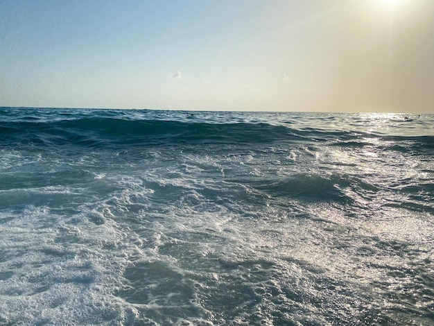 観光客の暖かい東の熱帯の休暇で海のビーチで水しぶきの波