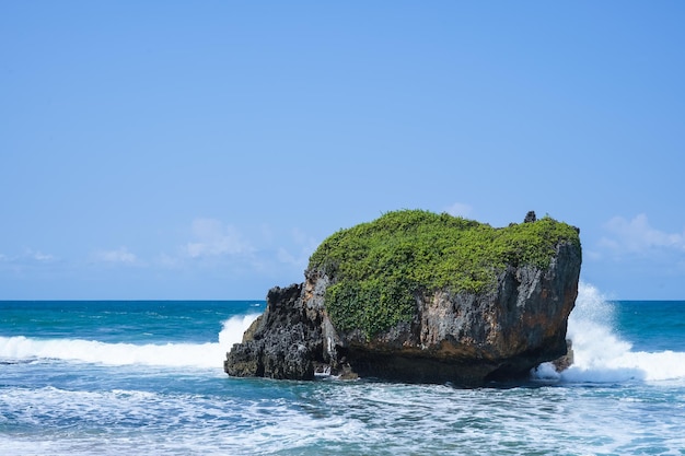 waves splashing on the rocks by the sea in mesra beach