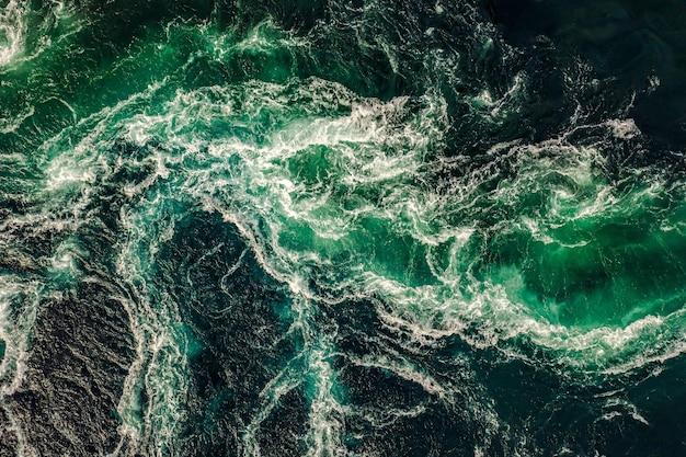 Waves of water of the river and the sea meet each other during high tide and low tide. whirlpools of the maelstrom of saltstraumen, nordland, norway
