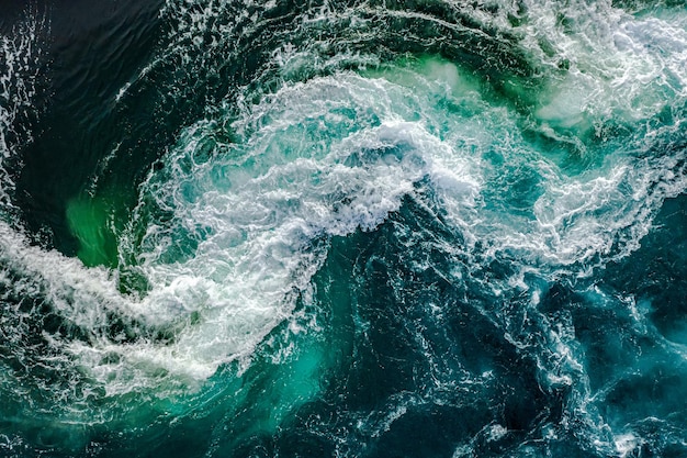 Waves of water of the river and the sea meet each other during high tide and low tide. Whirlpools of the maelstrom of Saltstraumen, Nordland, Norway