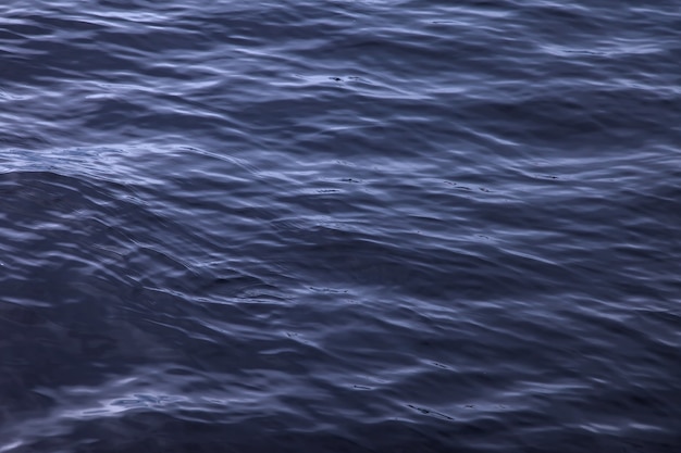 Waves on water surface. Wave pattern. View of surface fresh or sea water. Lapping sea waves. Background of sea or ocean wave. Water surface Wallpaper or background concept. Noise photo ripples water