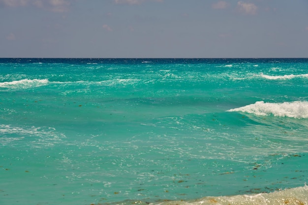 Waves with foam on the Caribbean coast in Mexico