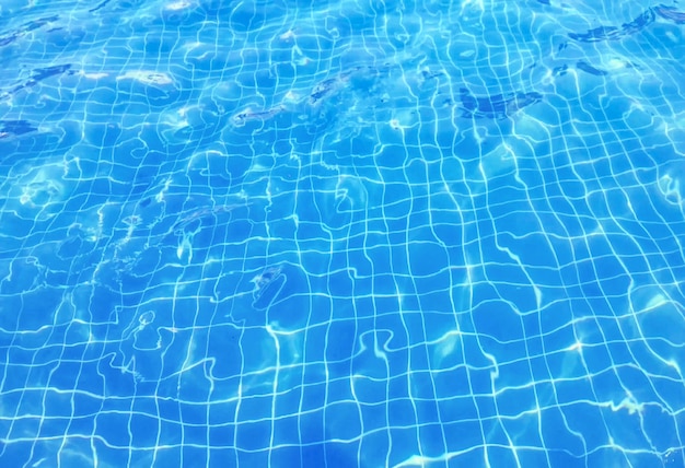 Waving blue swimming pool rippled water surface background.