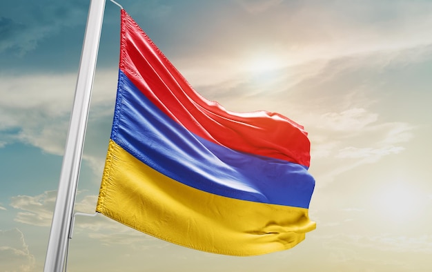 Waving Flag of Armenia in the Sky. The symbol of the state on wavy cotton fabric.