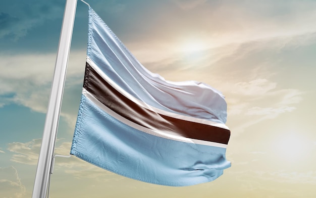 Waving Flag of Botswana in the Sky. The symbol of the state on wavy cotton fabric.