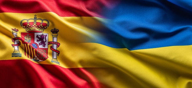 Waving flag concept of Ukraine and Spain symbolising political connection