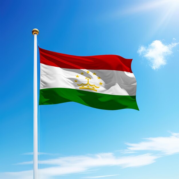 Waving flag of tajikistan on flagpole with sky background