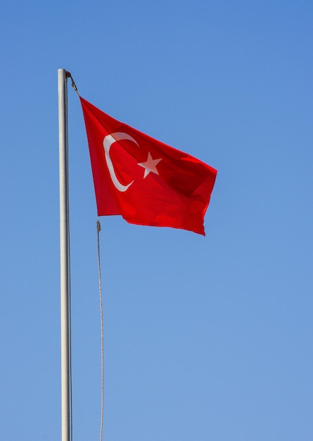 Waving flag of Turkey under sunny blue sky