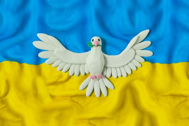 Waving flag of Ukraine with dove of peace Pray for Ukraine Stop Ukraine war Made of plasticine