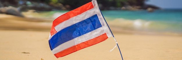 Waving thailand flag in the sunny blue sky with summer beach background vacation theme holiday