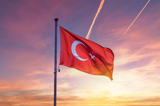 Waving Turkish flag against the background of the sunset sky