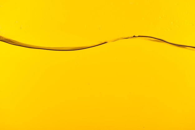 Wavy clear fresh water on yellow bright background