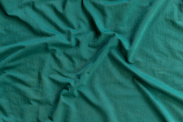 Wavy greenish fabric texture. abstract