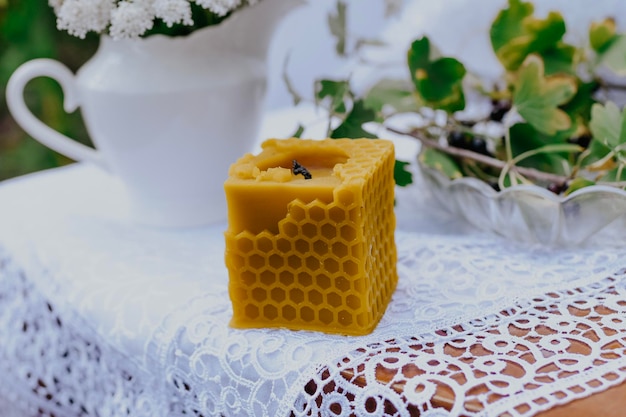 wax candle with rustic flowers on wooden table