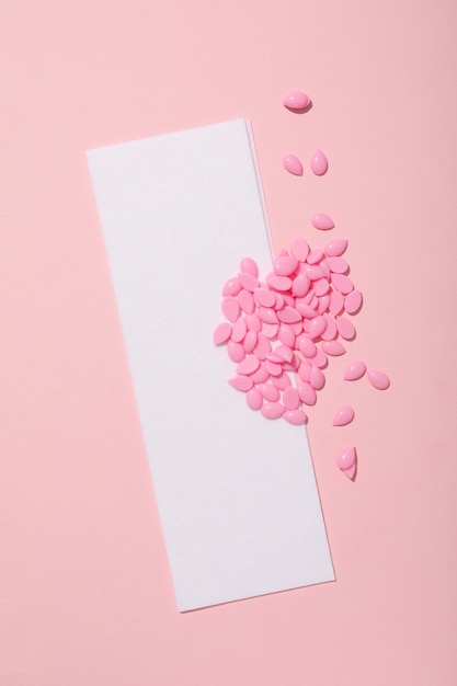 wax granules for depilation on a pink background