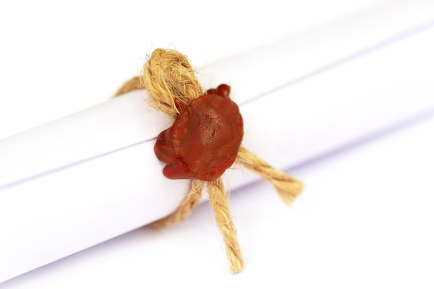 Wax seal on a rolled paper tied with roope