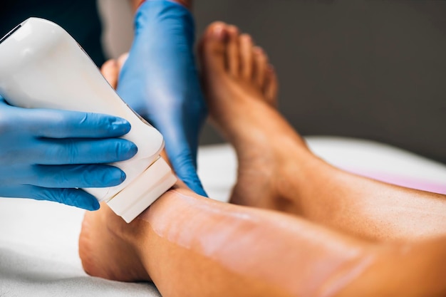 Waxing Legs Procedure in a Beauty Center