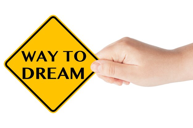 Way to Dream traffic sign in woman's hand on a white background