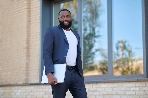 On the way to the office. A dark-skinned man in a suit on his way to work