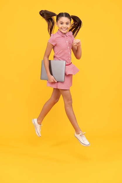 On way to success back to school modern digital communication happy teen girl work on laptop jumping kid find sales and discounts active child search social media cyber monday online