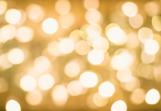 Wazig Bokeh Kerst Gloeiende Gouden Achtergrond. Kerstlichten. Gouden vakantie Nieuwjaar Abstract Glitter Defocused achtergrond met knipperende sterren en Sparks.