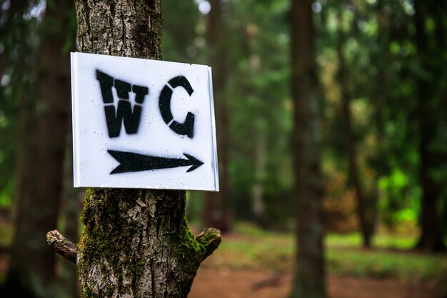 WC sign to the tree in naturexA