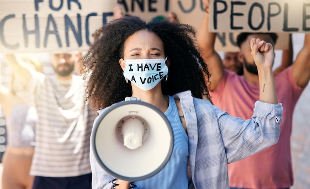 Photo we all have a voice. cropped portrait of a group of young people protesting in the city.