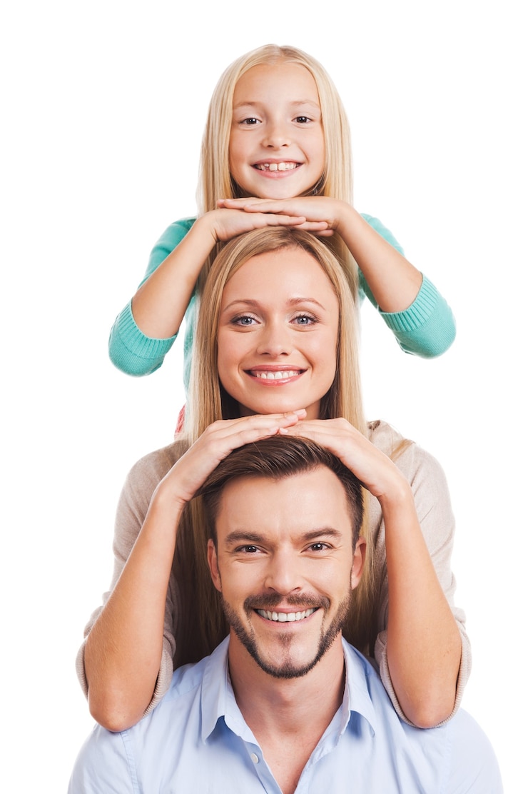 Photo we are family! happy family of three leaning at each other head and smiling while standing against white background