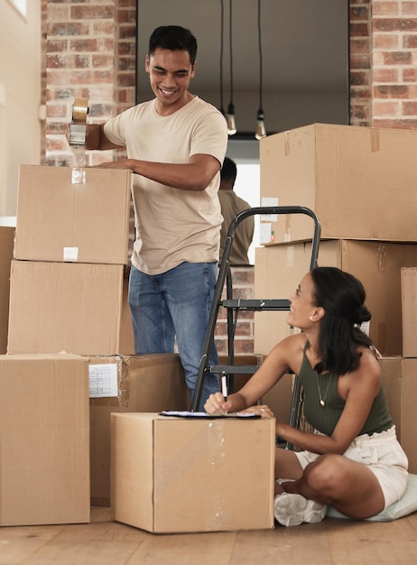 We are most alive when were in love Shot of a young couple packing up to move in a room at home