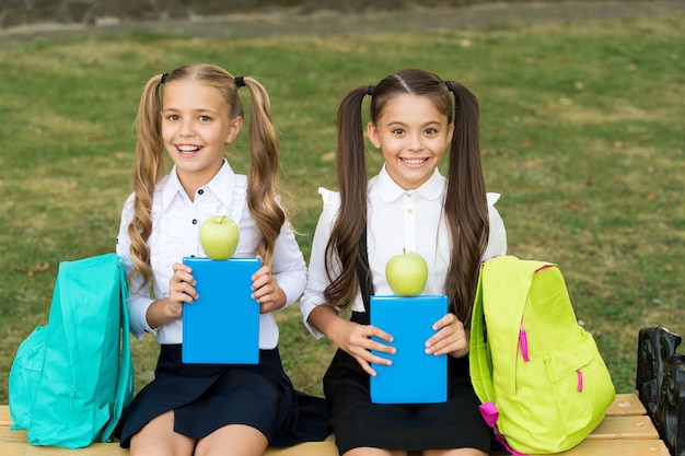 We are vegetarian. Happy children hold green apples outdoors. Eating fruits for snack. Vegetarian food. School break. Vegetarian diet. Healthy vegetarian nutrition. For better health.