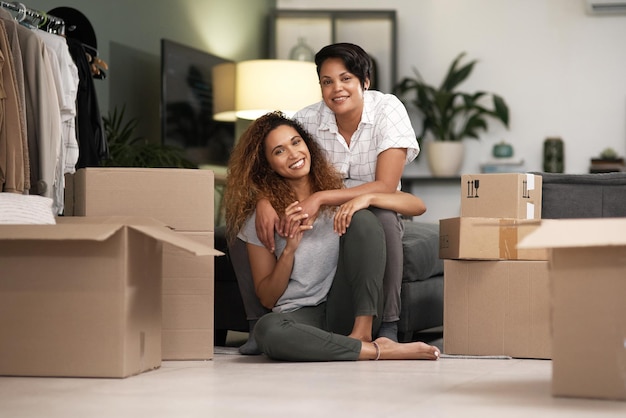 We both pitch in Shot of a couple unpacking boxes in their new home