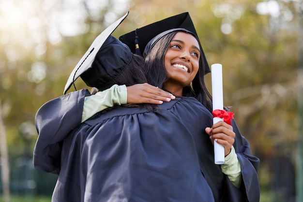 We did it. Cropped shot of an attractive young female student hugging her friend while celebrating on graduation day.