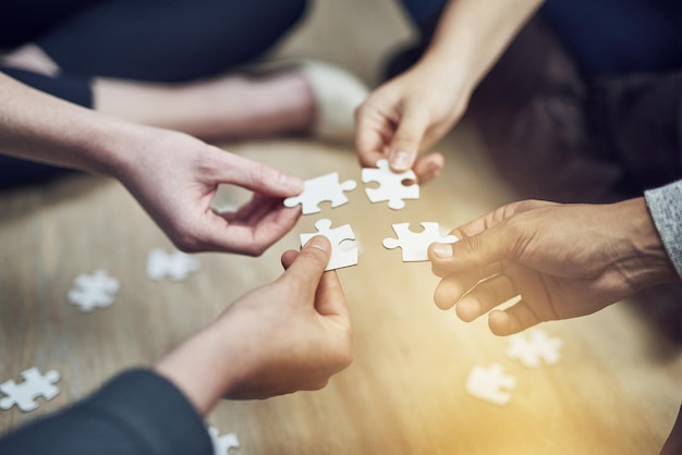 We fit together Shot of a group of people building a puzzle together